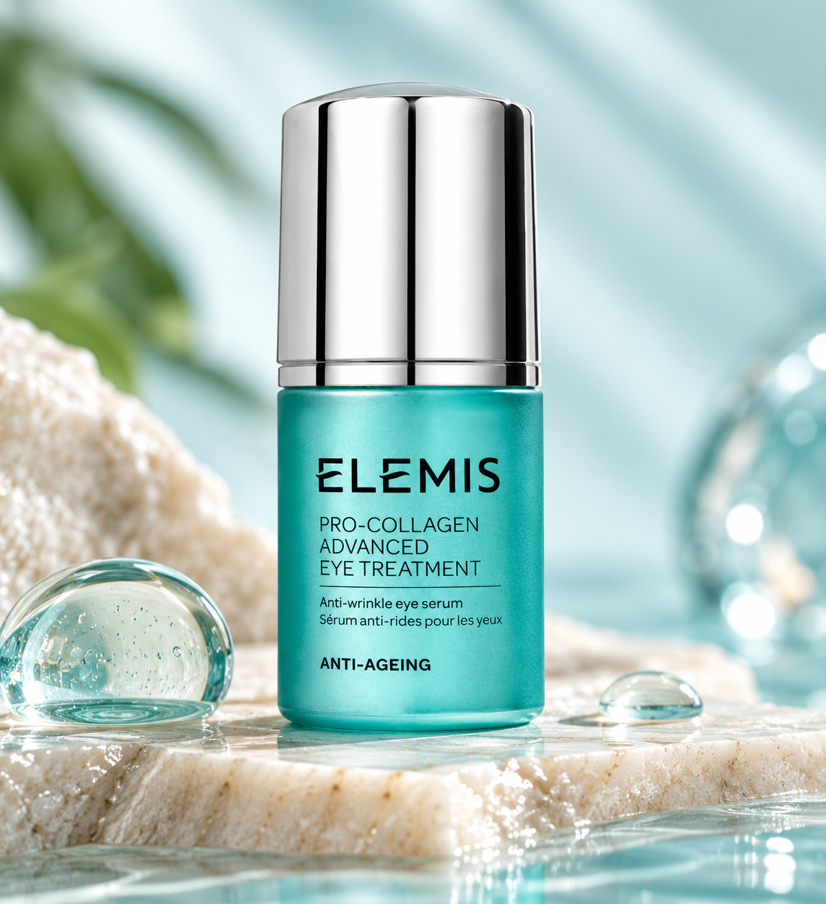 ELEMIS Pro-Collagen Advanced Eye Treatment anti-wrinkle eye serum in an elegant turquoise bottle with a silver cap, displayed on natural stone beside crystal-clear water droplets and soft greenery. Luxury anti-aging eye treatment designed to hydrate the delicate eye area and reduce the appearance of fine lines and wrinkles.