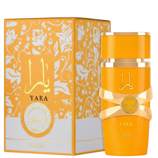 A bright mango-yellow cylindrical bottle of Lattafa Yara Tous Eau De Parfum with an interlocking gold ribbon design, standing next to its large yellow-and-white box featuring intricate floral patterns and gold branding.