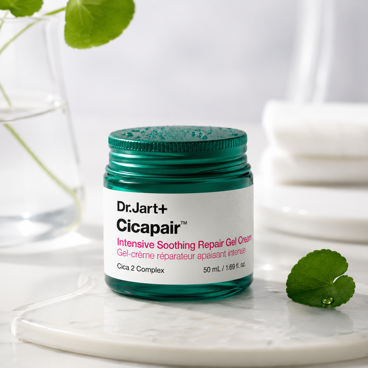 Dr.Jart+ Cicapair Intensive Soothing Repair Gel Cream 50ml elegantly displayed on a white marble tray in a bright spa-inspired setting with fresh Centella asiatica leaves, clear glassware, soft towels and gentle natural light, highlighting the calming, repairing and hydrating benefits of this premium Korean skincare moisturizer for sensitive skin.
